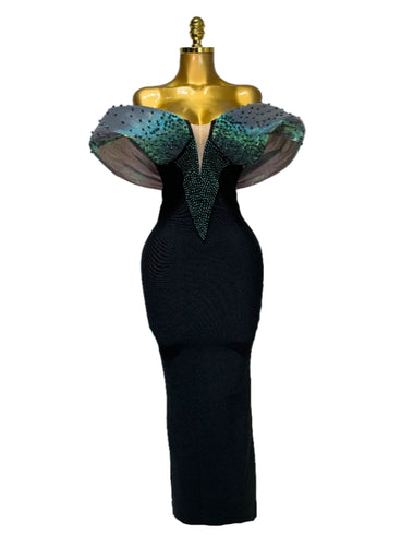 Black evening gown with teal embellishments on a mannequin against a white background