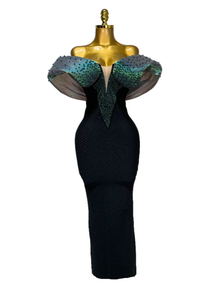 Black evening gown with teal embellishments on a mannequin against a white background
