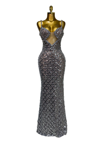 Silver sequin evening gown on a mannequin against a plain background