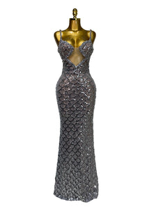 Silver sequin evening gown on a mannequin against a plain background