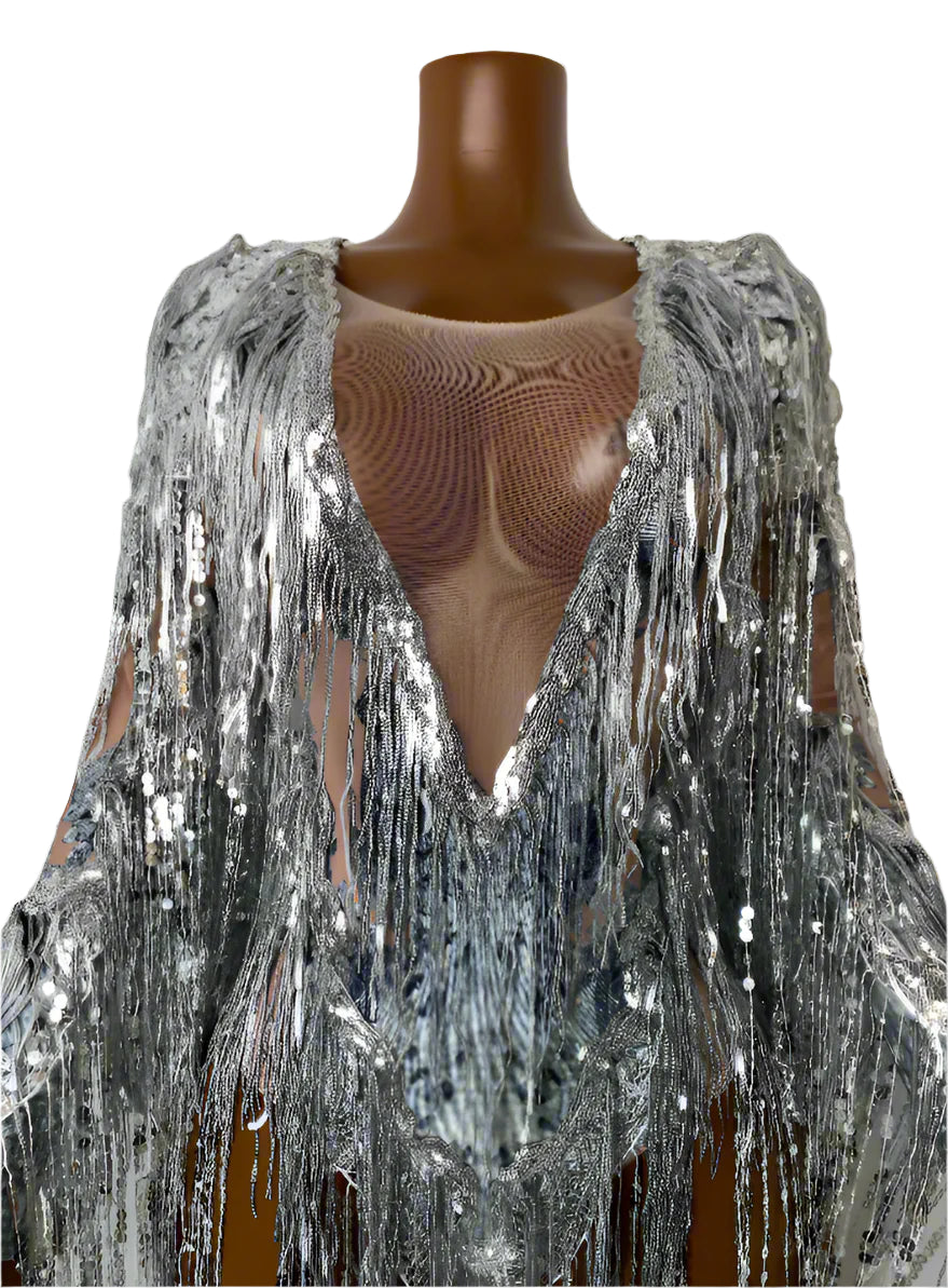 Mannequin wearing a silver sequin fringe garment against a plain background